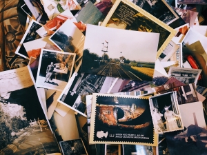various photographs and postcards in a pile in a visually appealing way